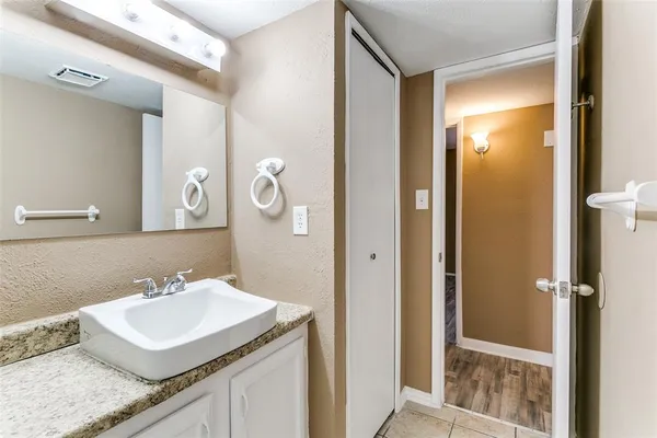 a bathroom with a sink a mirror and a shower