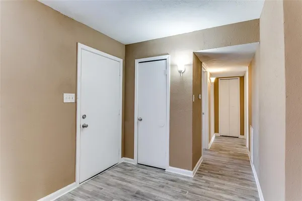 a view of a hallway with wooden floor