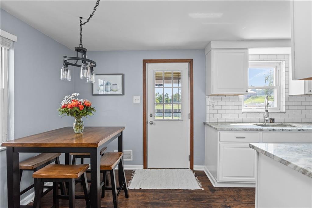 56 Elizabeth Street Pittsburgh, PA 15209 - Photo 13 of 30 a dining room with wooden floor a chandelier a wooden table and chairs