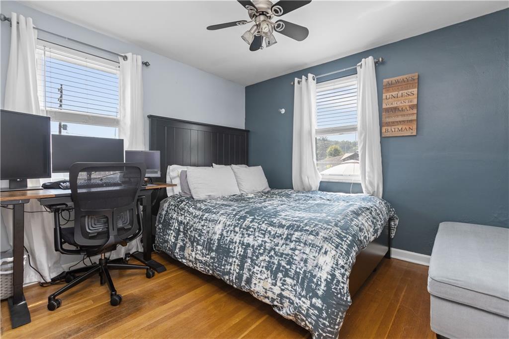 56 Elizabeth Street Pittsburgh, PA 15209 - Photo 19 of 30 a bedroom with a bed and a chandelier