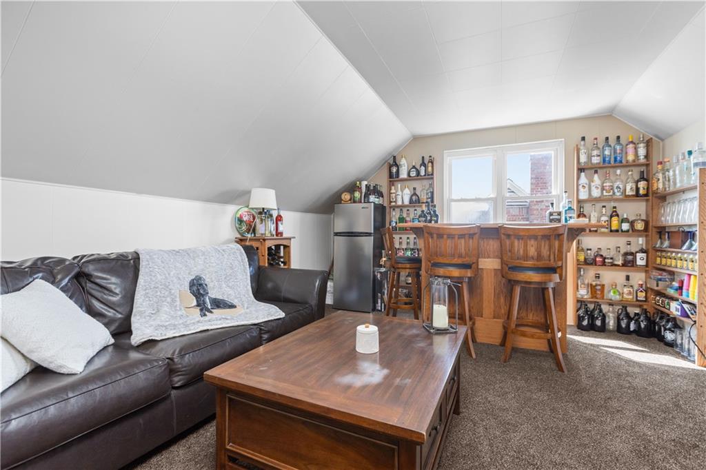 56 Elizabeth Street Pittsburgh, PA 15209 - Photo 25 of 30 a living room with a couch and a dining table