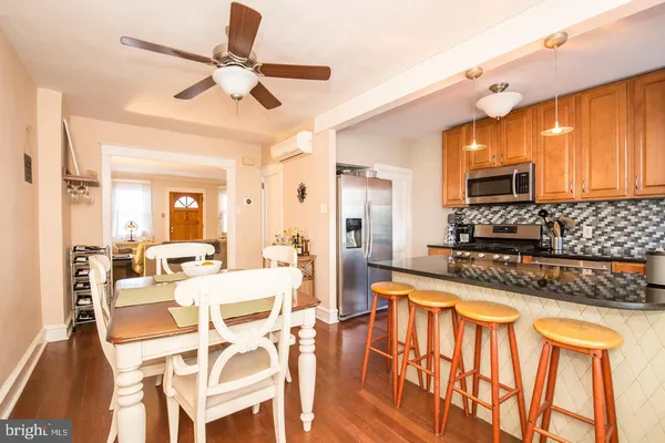 a large kitchen with a table chairs stove and refrigerator
