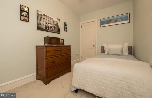 a bedroom with a bed and a desk