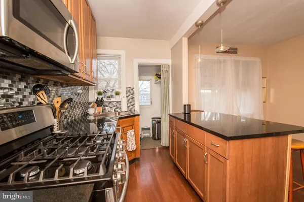 a kitchen with stainless steel appliances granite countertop a stove and a sink