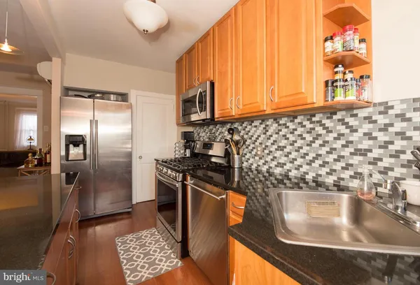 a kitchen with a sink and a refrigerator