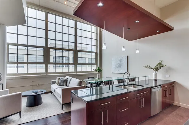 a kitchen with stainless steel appliances kitchen island granite countertop a sink and cabinets