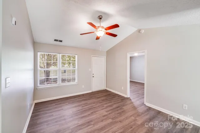 a view of an empty room and wooden floor