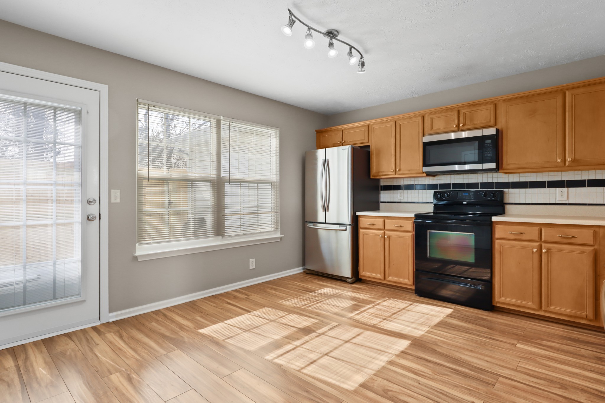 245 Shoshone Place Murfreesboro, TN 37128 - Photo 5 of 23 a kitchen with granite countertop a refrigerator and a stove top oven