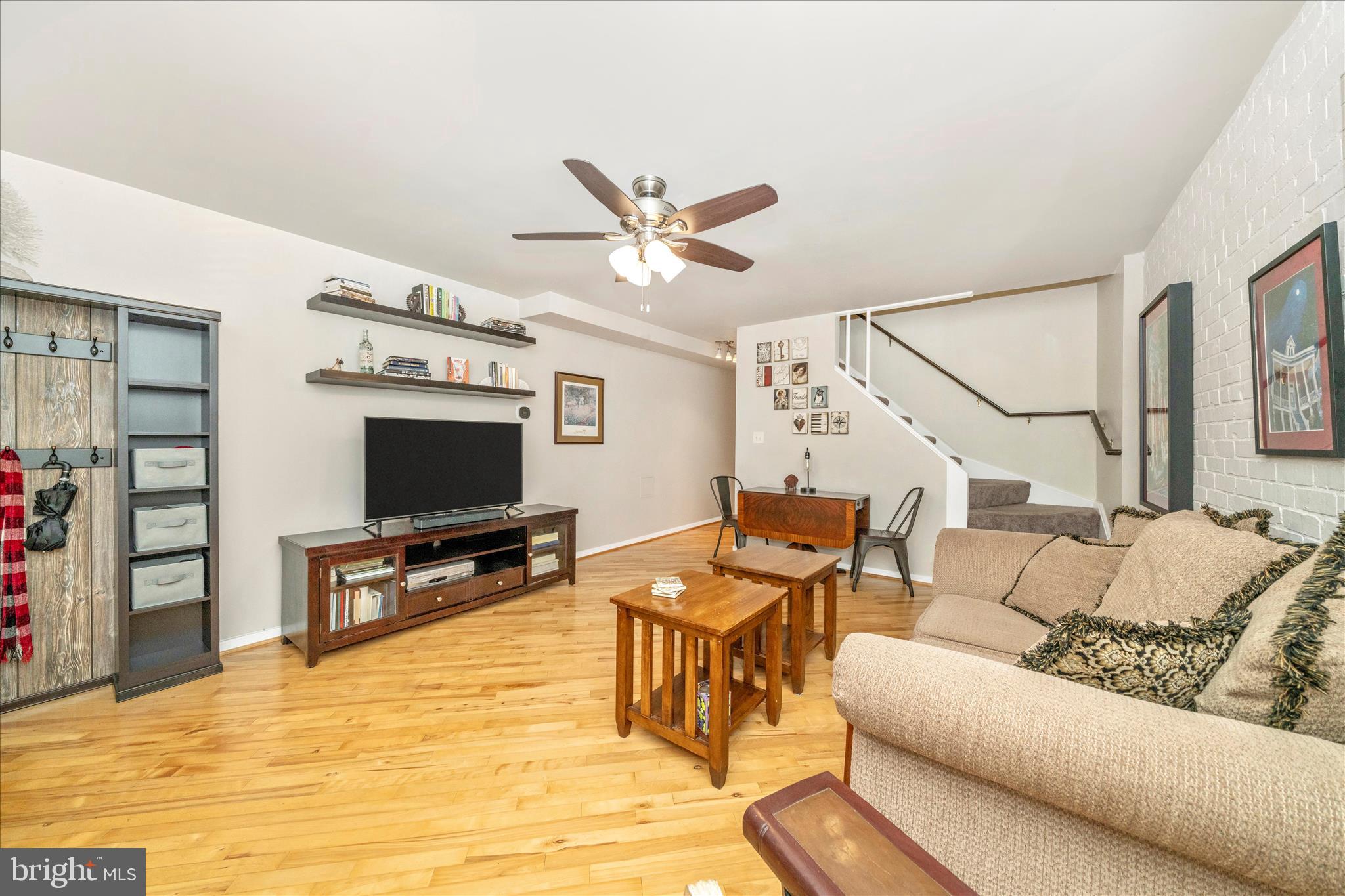 103 East 8th Street, Unit 103C Frederick, MD 21701 - Photo 5 of 34 a living room with furniture and a flat screen tv