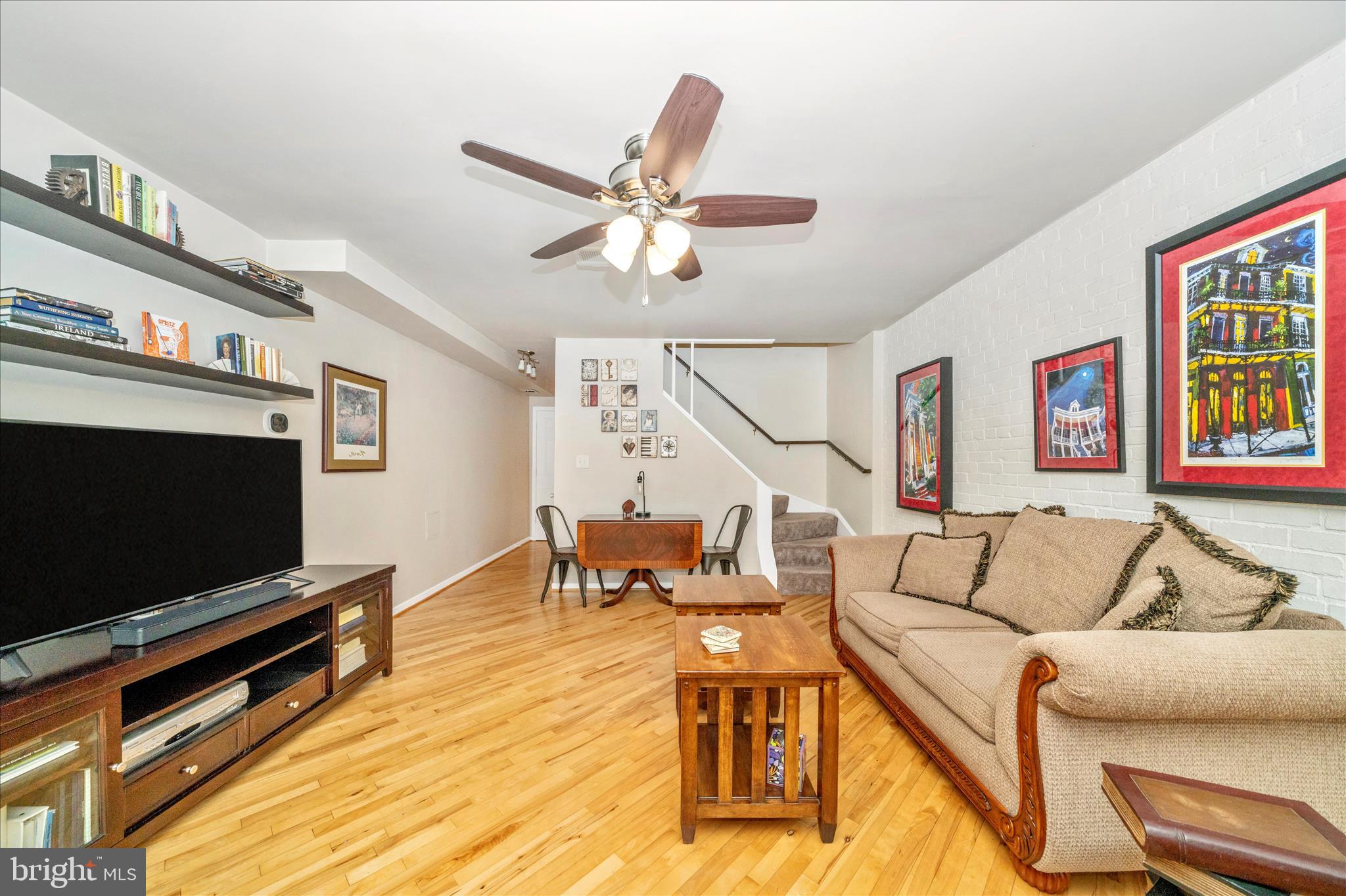 103 East 8th Street, Unit 103C Frederick, MD 21701 - Photo 8 of 34 a living room with furniture and a flat screen tv
