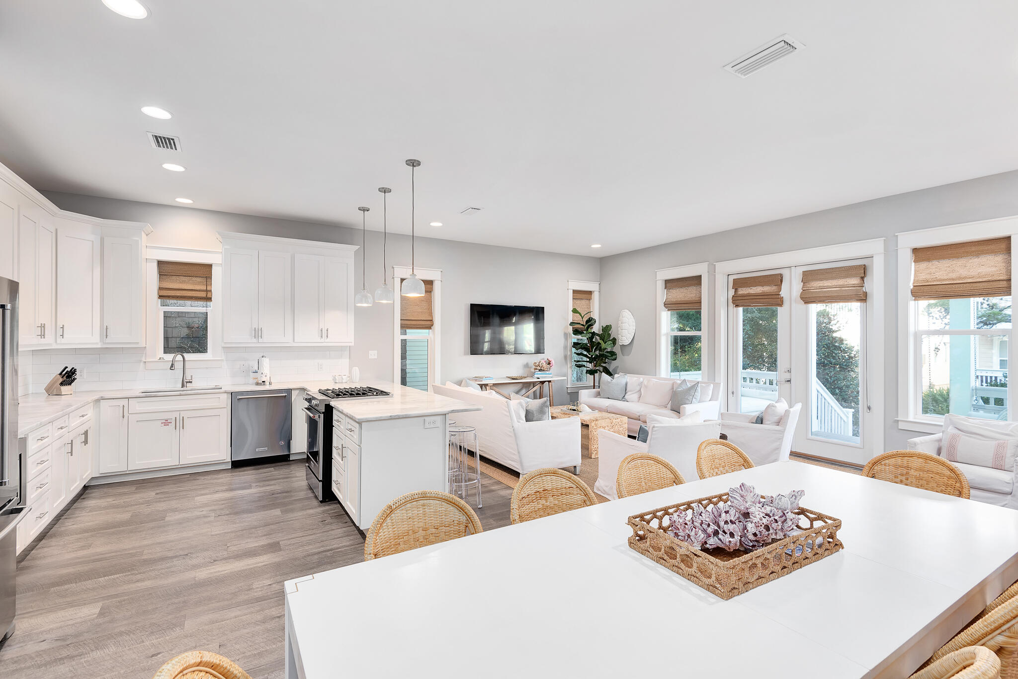 110 Surfer Lane Inlet Beach, FL 32461 - Photo 4 of 55 a large white kitchen with a stove a sink dishwasher and white cabinets with wooden floor