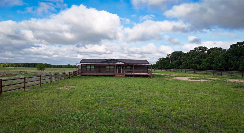 623 County Road 123 Comanche, TX 76442 - Photo 1 of 26 a view of a house with a yard and sitting area