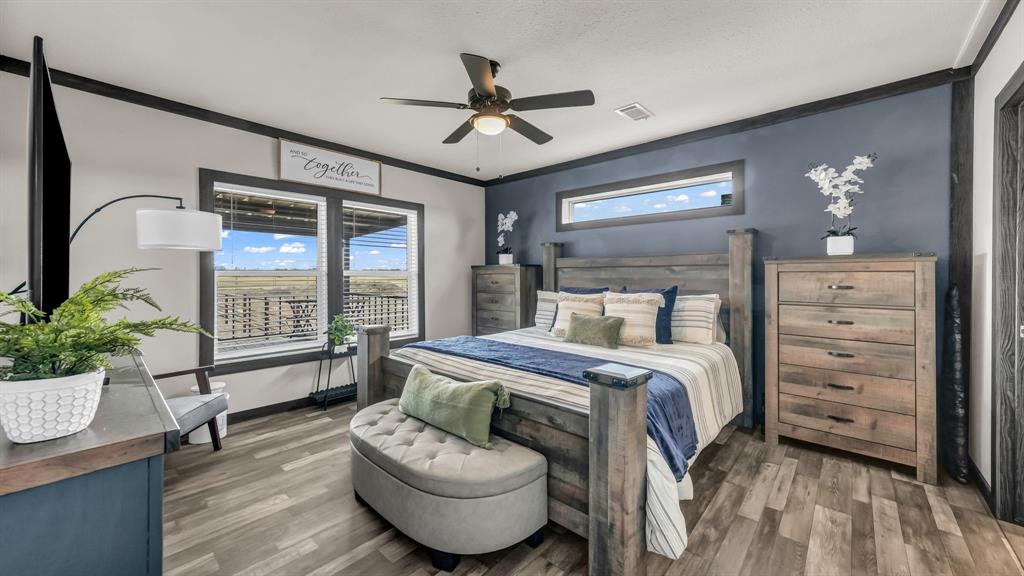 623 County Road 123 Comanche, TX 76442 - Photo 11 of 26 a bedroom with a bed and a chandelier