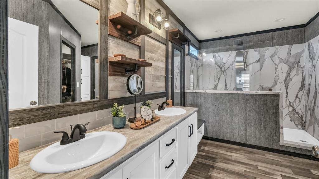 623 County Road 123 Comanche, TX 76442 - Photo 12 of 26 a bathroom with a double vanity sink and mirror