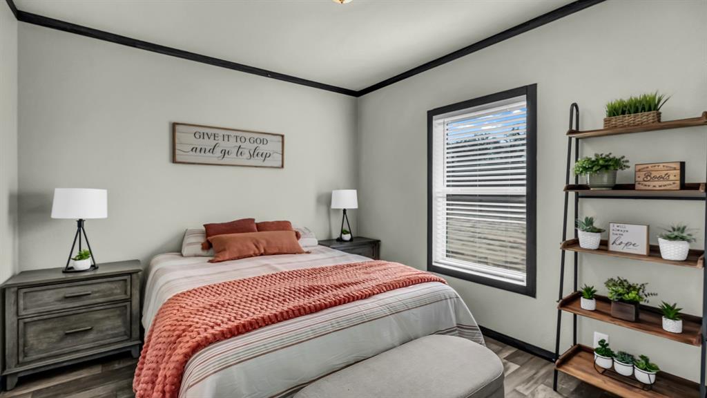 623 County Road 123 Comanche, TX 76442 - Photo 14 of 26 a bedroom with a bed and wooden floor