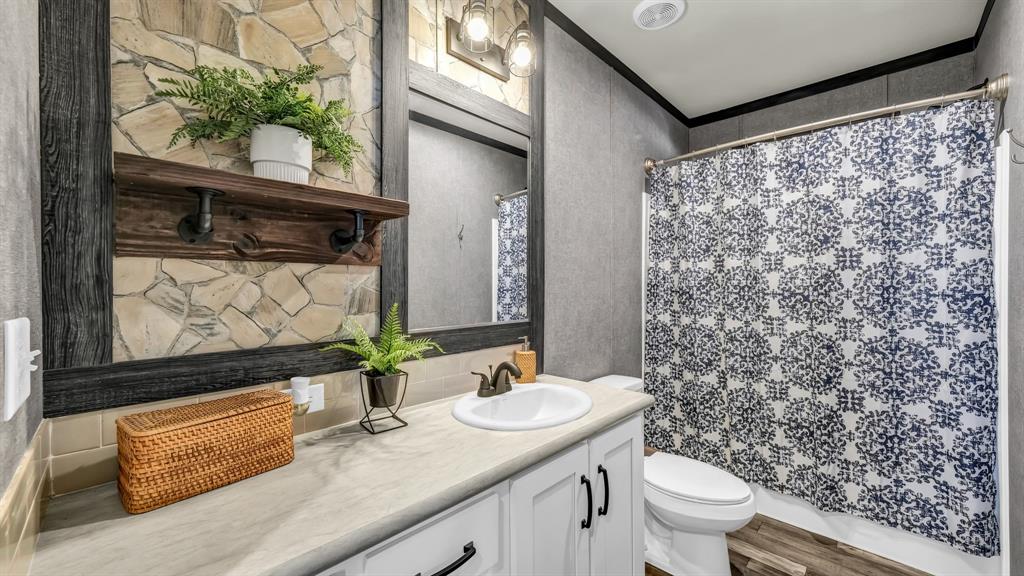 623 County Road 123 Comanche, TX 76442 - Photo 17 of 26 a bathroom with a granite countertop sink and a mirror