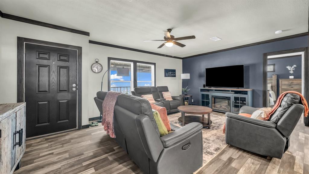 623 County Road 123 Comanche, TX 76442 - Photo 5 of 26 a living room with furniture and a flat screen tv