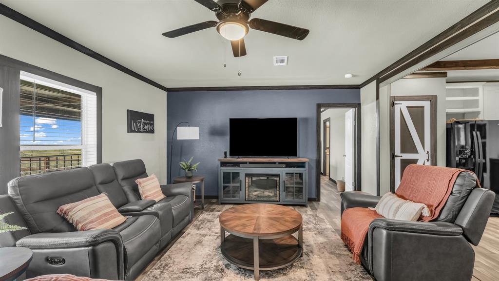 623 County Road 123 Comanche, TX 76442 - Photo 7 of 26 a living room with furniture and a flat screen tv
