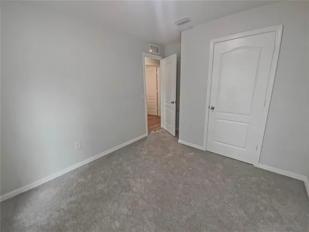 a view of an empty room and closet area
