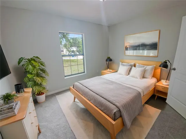 a bedroom with a bed and a window