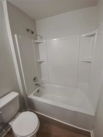 a bathroom with a toilet and a bathtub