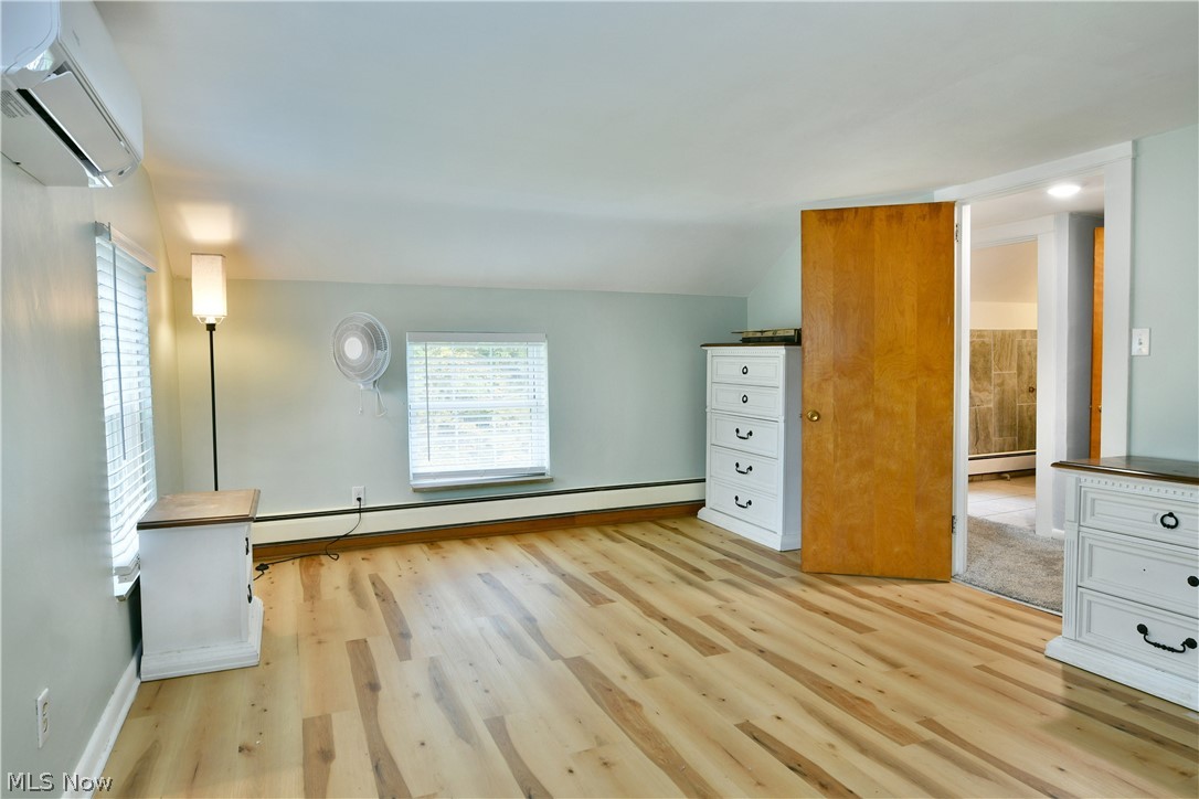 892 Yankee Run Road Masury, OH 44438 - Photo 29 of 50 Wood-finish flooring with horizontal blinds and a wall-mounted air conditioning unit