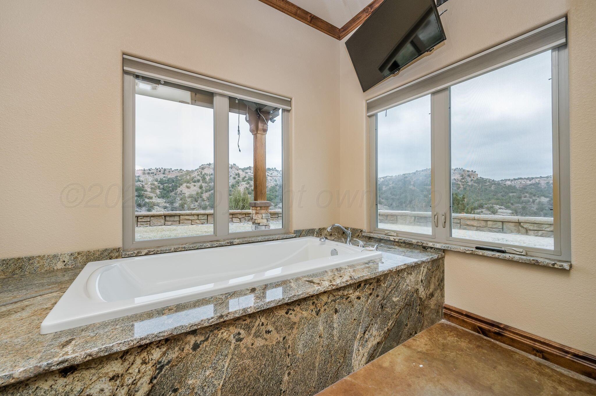 8150 Little Fox Trail Amarillo, TX 79118 - Photo 26 of 69 a bathroom with bathtub and window