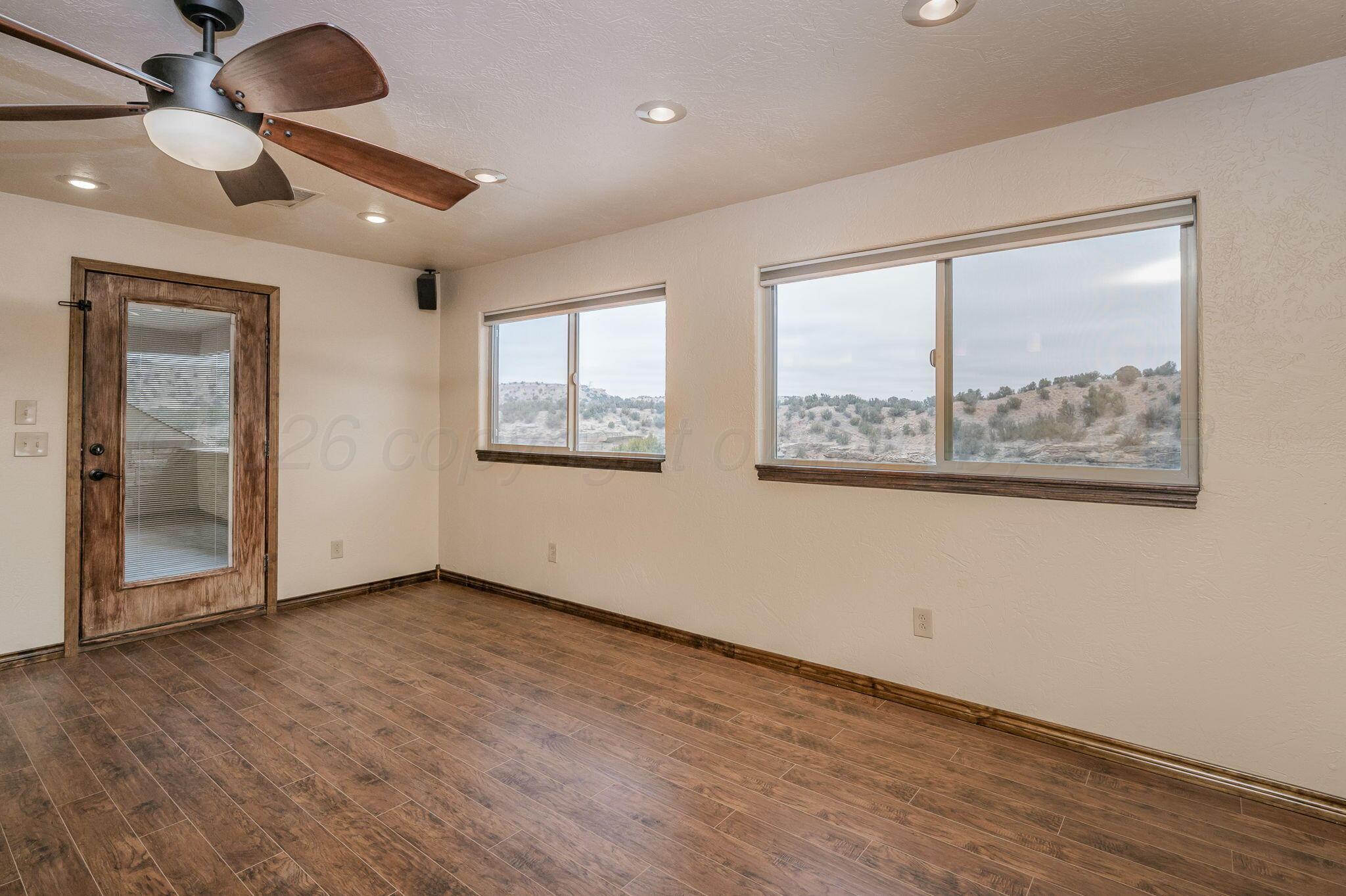 8150 Little Fox Trail Amarillo, TX 79118 - Photo 41 of 69 an empty room with wooden floor fan and windows