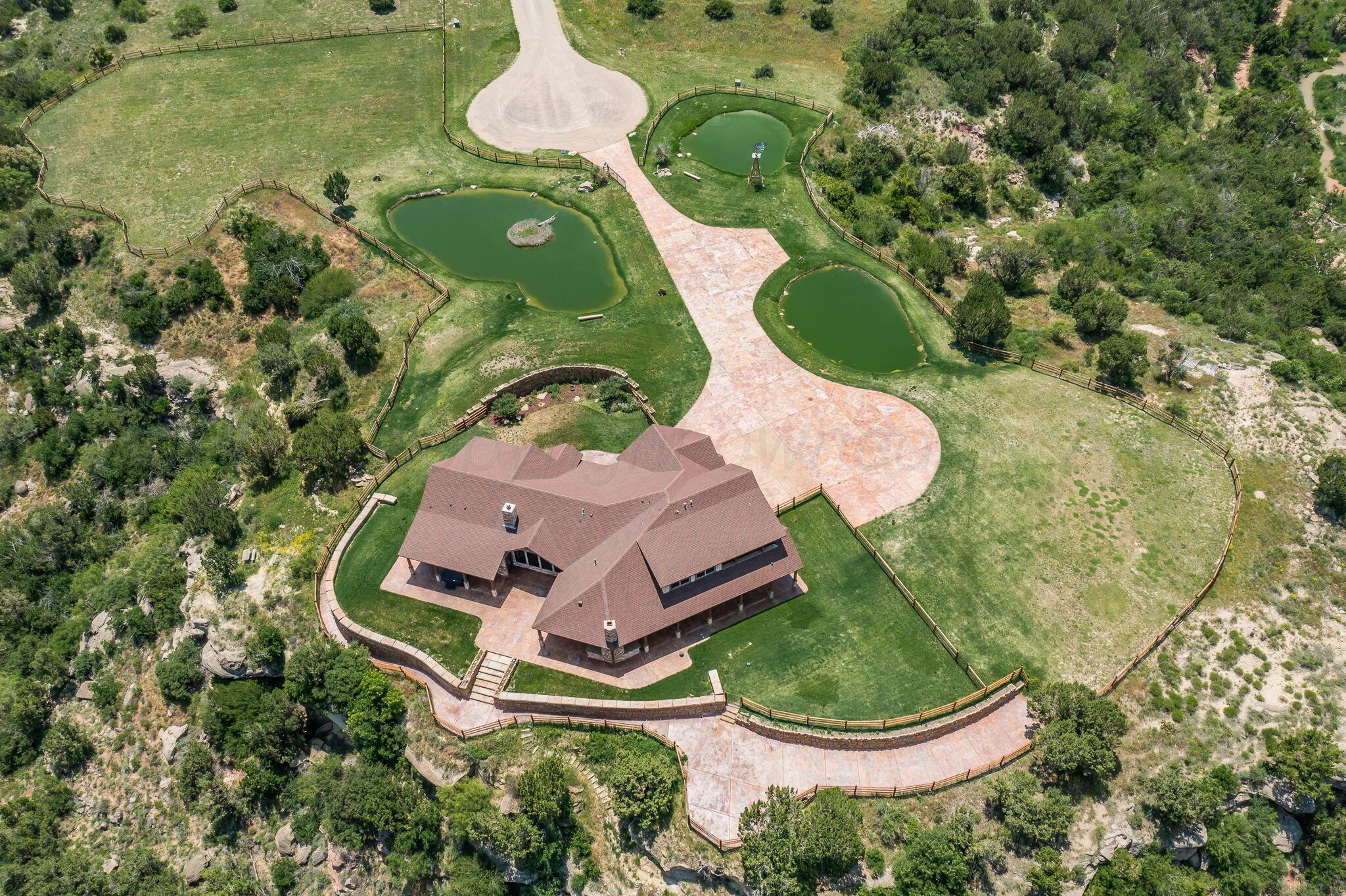 8150 Little Fox Trail Amarillo, TX 79118 - Photo 58 of 69 an aerial view of a house with a yard and greenery