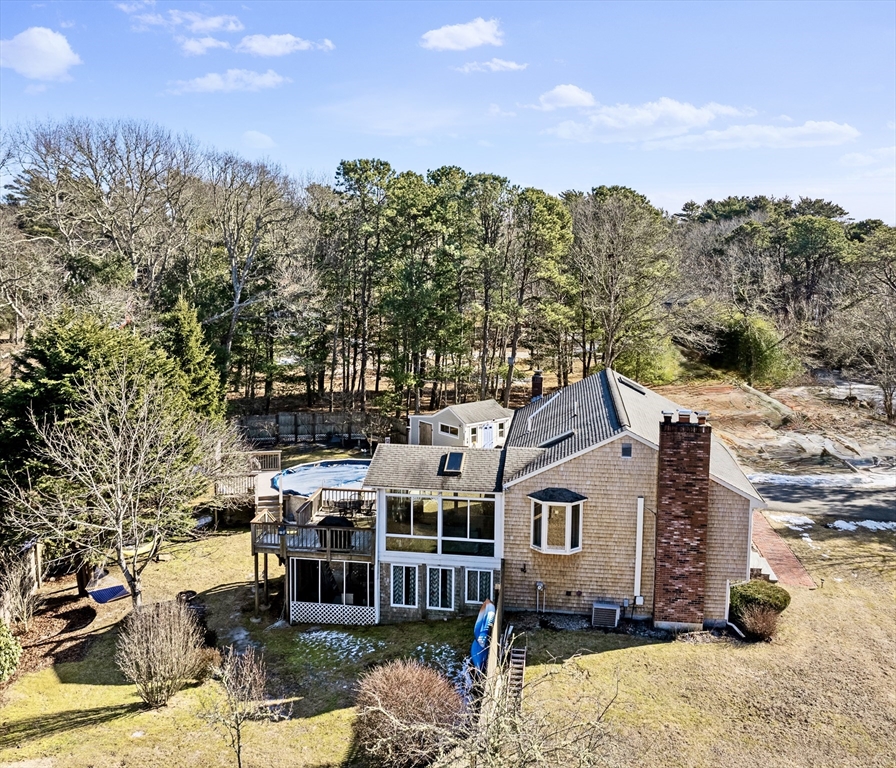 a aerial view of a house with a yard covered with snow in the background