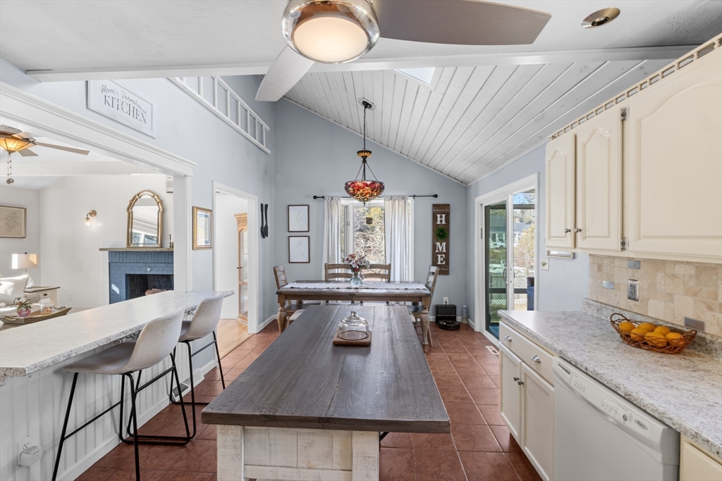 7 Carol Road Wareham, MA 02532 - Photo 18 of 42 a kitchen with stainless steel appliances granite countertop a stove a sink dishwasher a dining table and chairs with wooden floor