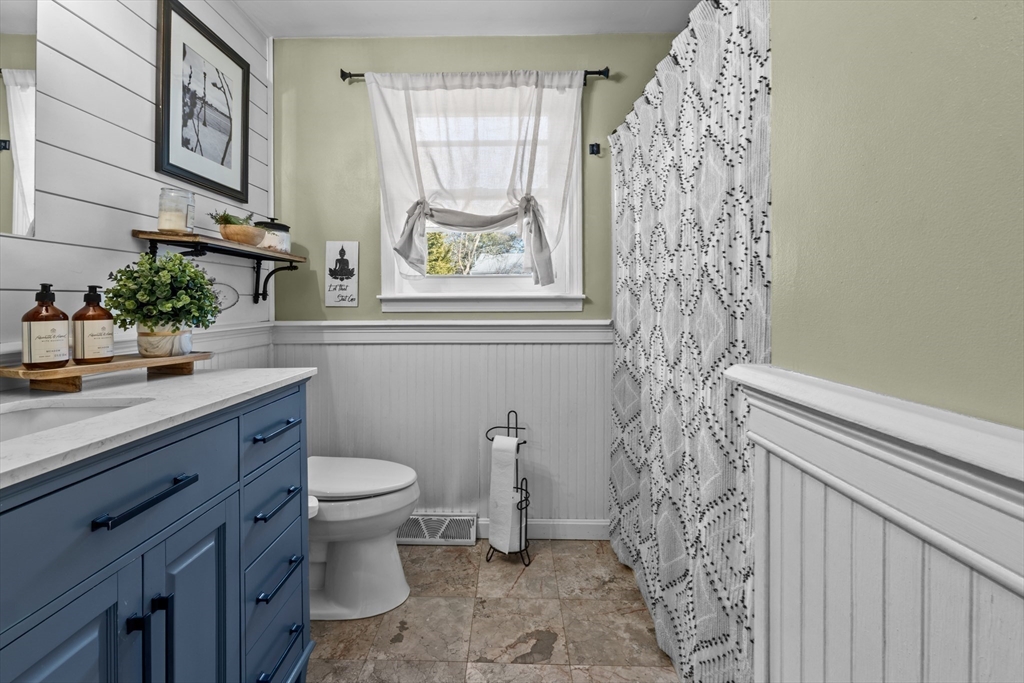 7 Carol Road Wareham, MA 02532 - Photo 21 of 42 a bathroom with a granite countertop toilet a sink and a mirror