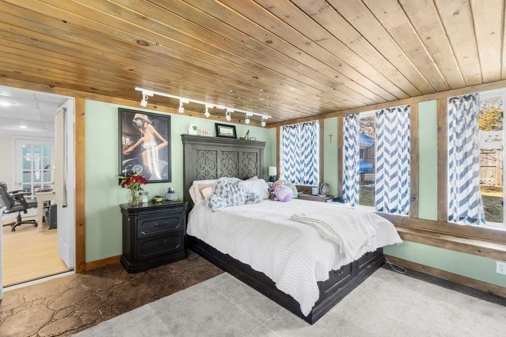 7 Carol Road Wareham, MA 02532 - Photo 36 of 42 a large bed sitting in a bedroom next to a window