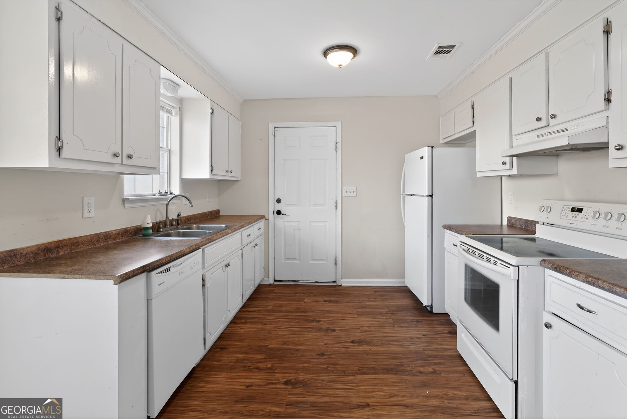 2764 Davis Mill Road Hephzibah, GA 30815 - Photo 11 of 29 a large kitchen with cabinets stainless steel appliances a sink and wooden floor