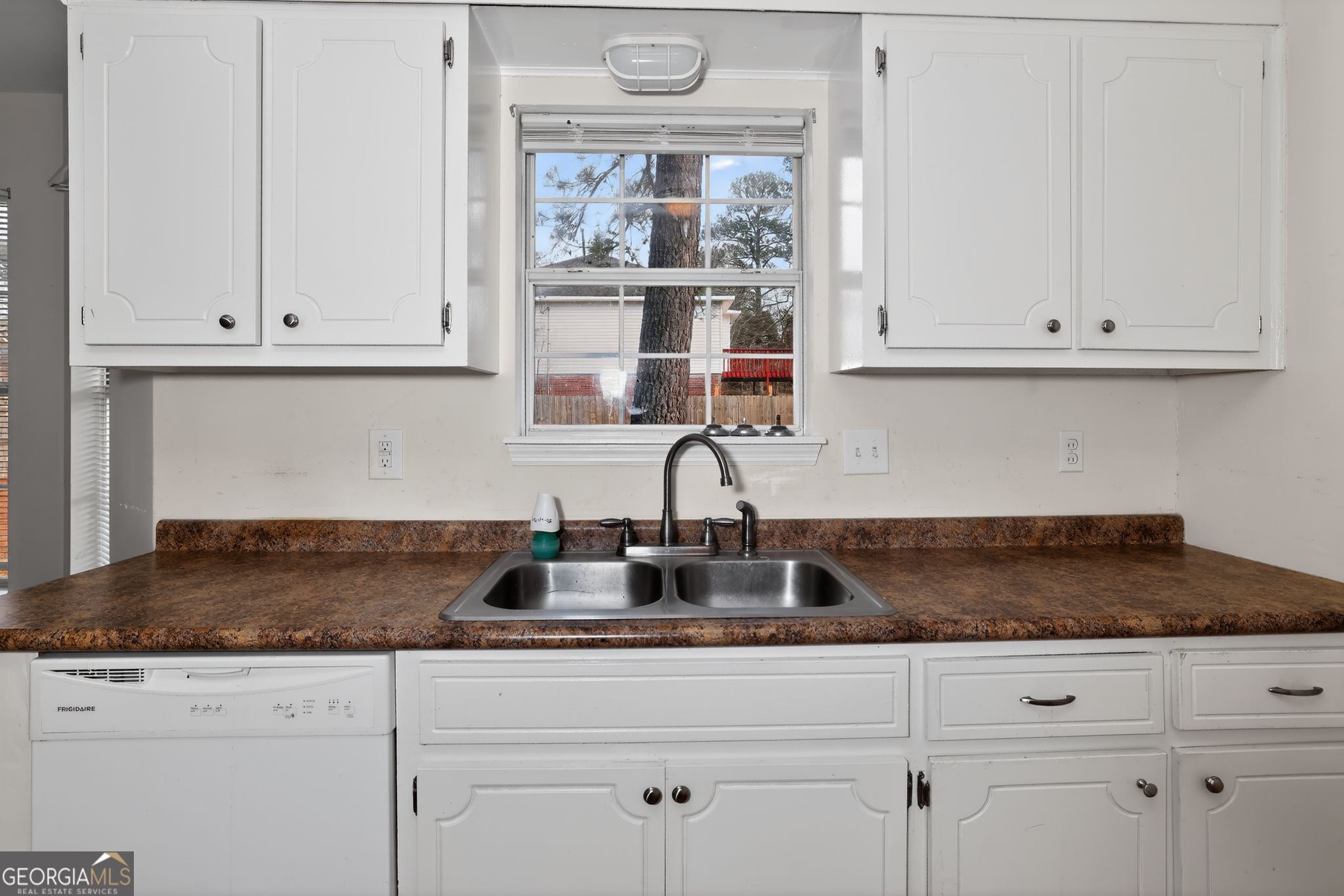 2764 Davis Mill Road Hephzibah, GA 30815 - Photo 13 of 29 a kitchen with granite countertop white cabinets and a window