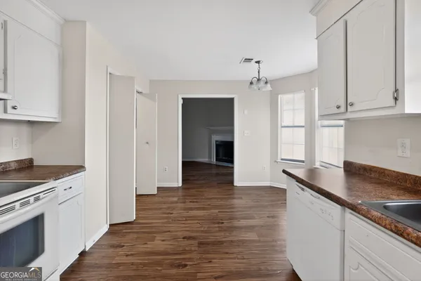 a kitchen with granite countertop a stove and a refrigerator