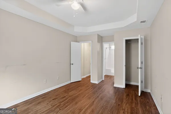 a view of an empty room with wooden floor