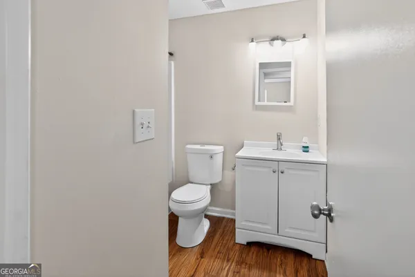 a bathroom with a toilet sink and mirror