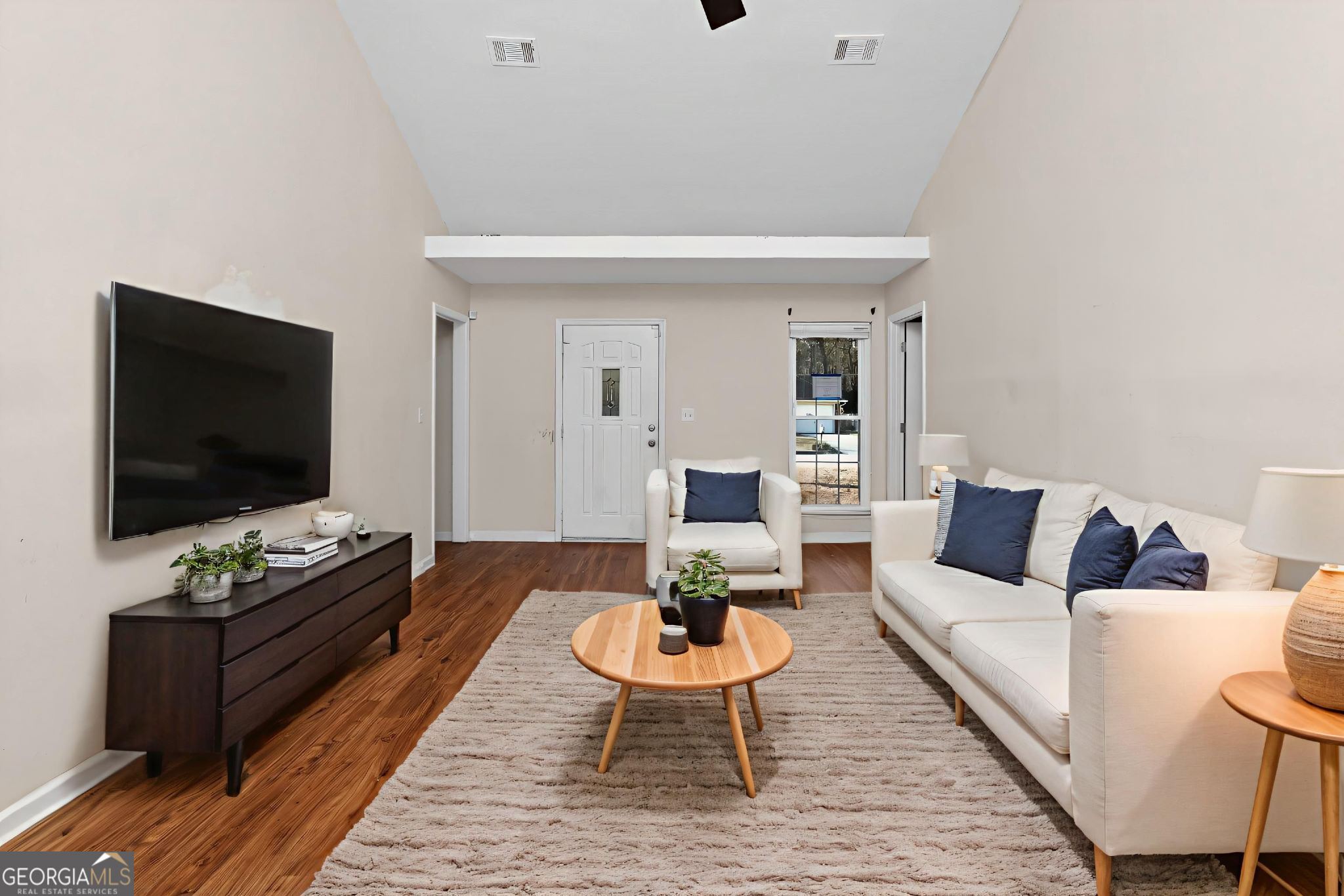 2764 Davis Mill Road Hephzibah, GA 30815 - Photo 6 of 29 a living room with furniture a flat screen tv and a table