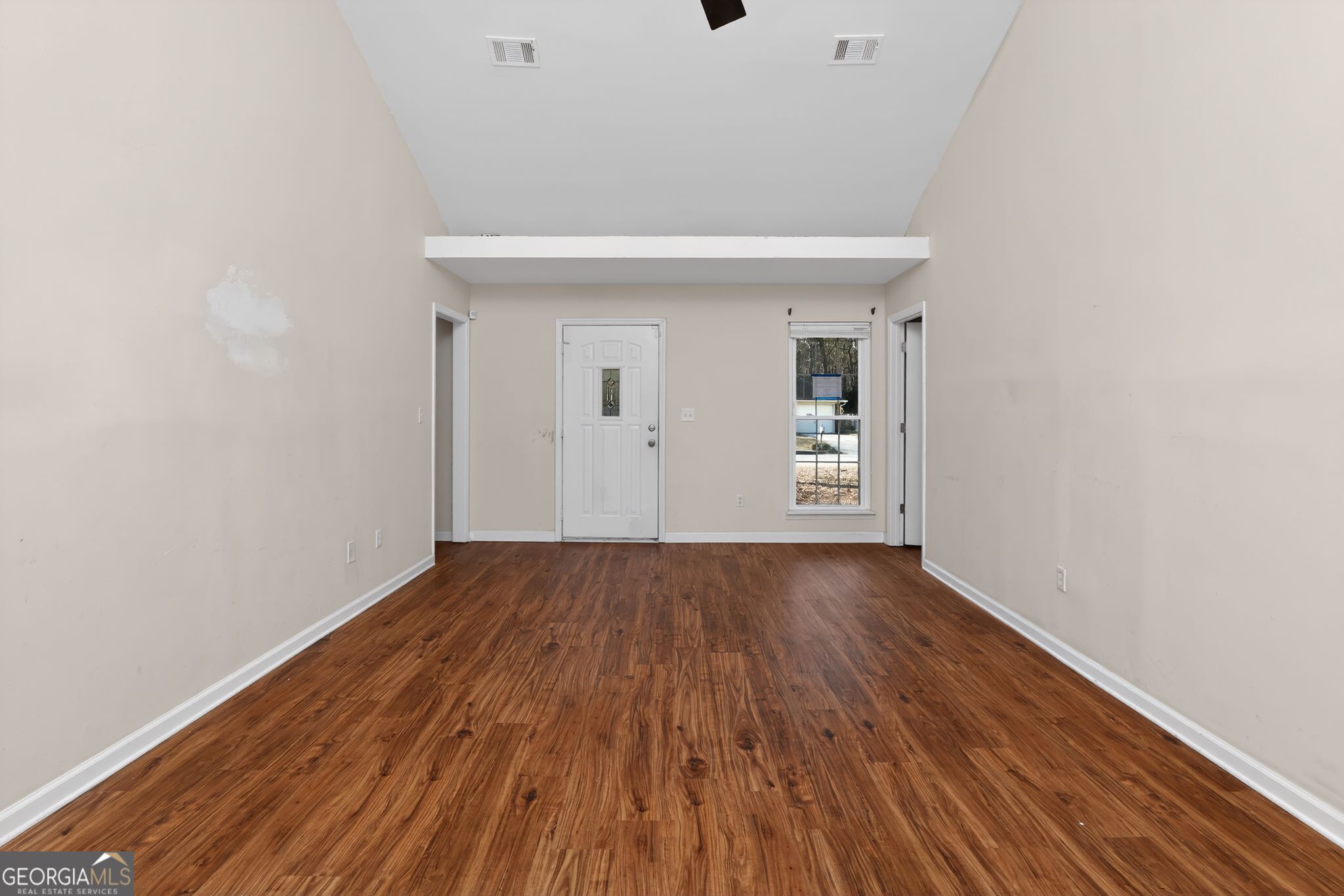 2764 Davis Mill Road Hephzibah, GA 30815 - Photo 7 of 29 a view of an empty room with wooden floor and a window
