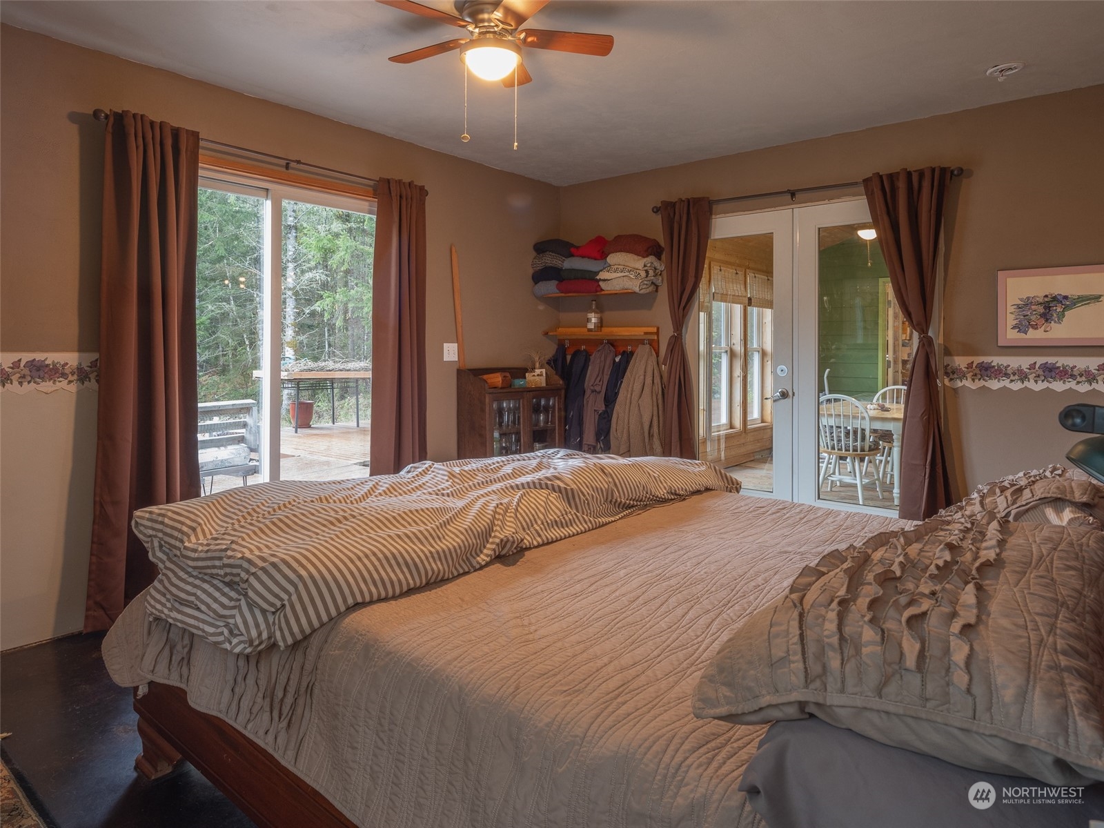 1395 Little Quil Road Quilcene, WA 98376 - Photo 14 of 39 a bedroom with a bed and a chandelier