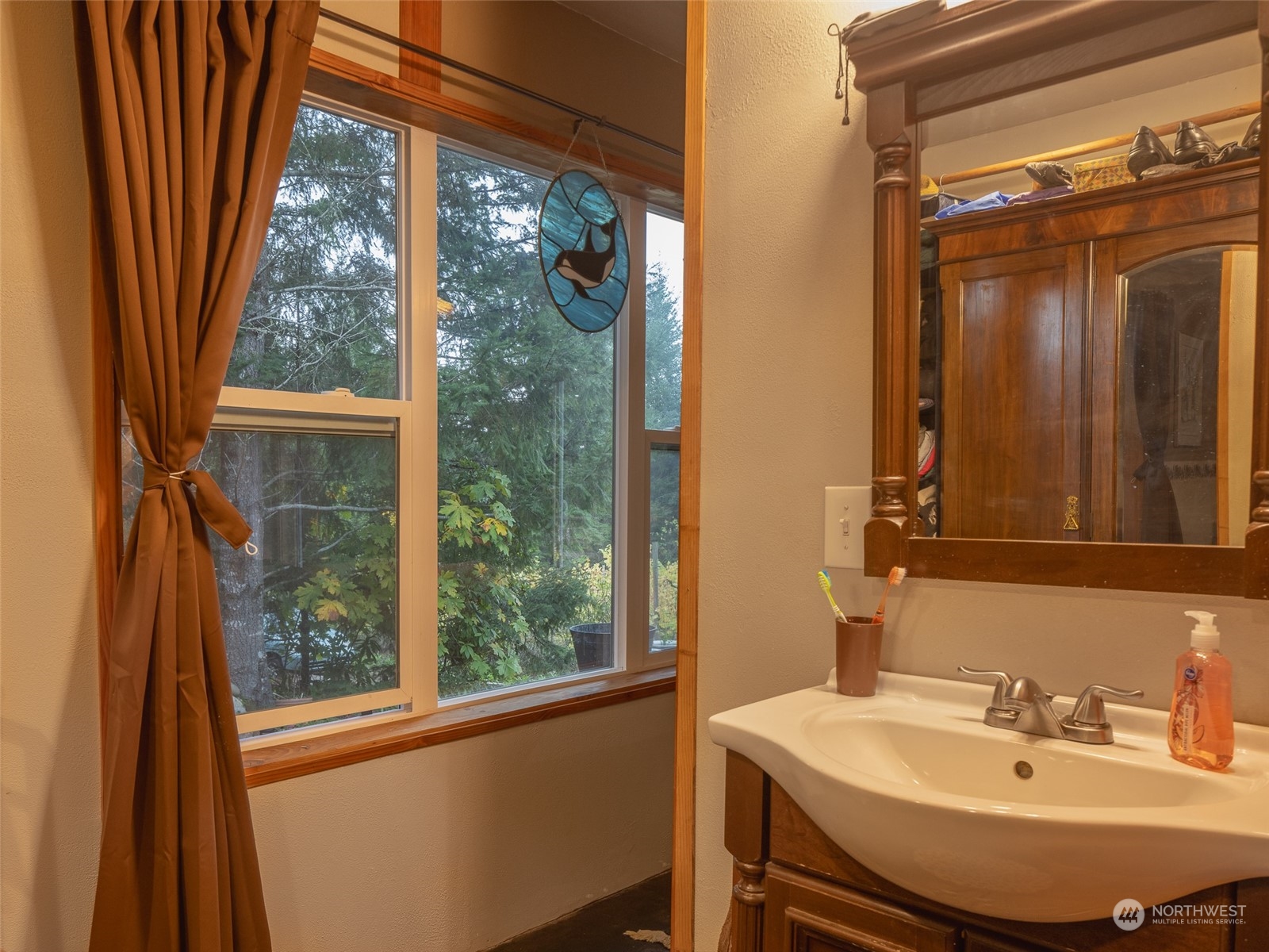 1395 Little Quil Road Quilcene, WA 98376 - Photo 16 of 39 a bathroom with a sink a mirror and a window