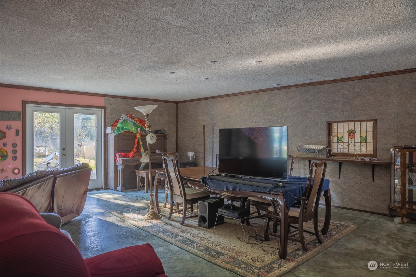 1395 Little Quil Road Quilcene, WA 98376 - Photo 23 of 39 a living room with furniture and a flat screen tv