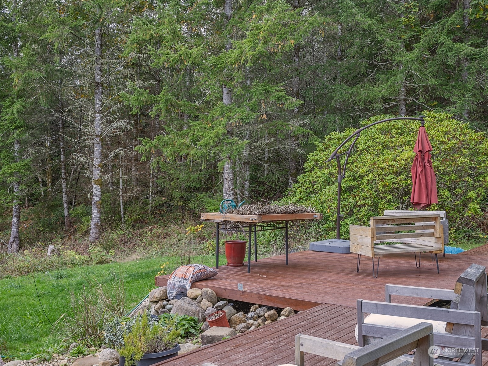 1395 Little Quil Road Quilcene, WA 98376 - Photo 7 of 39 a view of a backyard with couches plants and large trees