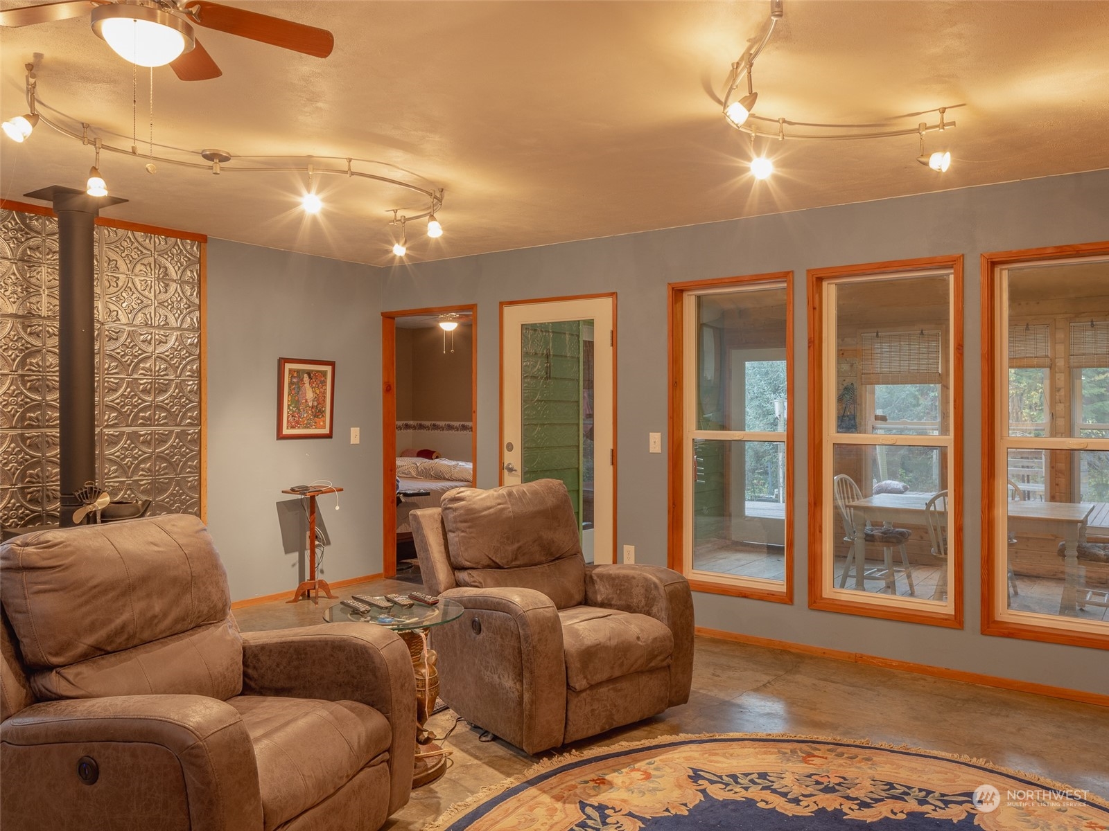 1395 Little Quil Road Quilcene, WA 98376 - Photo 9 of 39 a living room with furniture and large windows