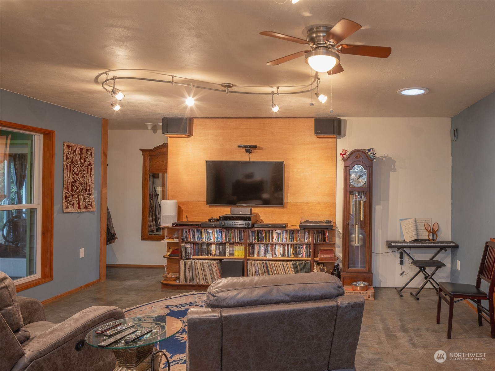 1395 Little Quil Road Quilcene, WA 98376 - Photo 10 of 39 a living room with furniture and a flat screen tv