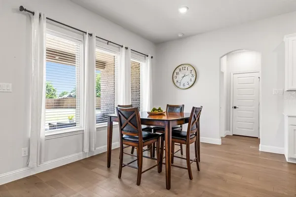 a view of a dining room with furniture and a large window