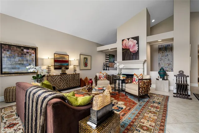 a living room with fireplace furniture and windows
