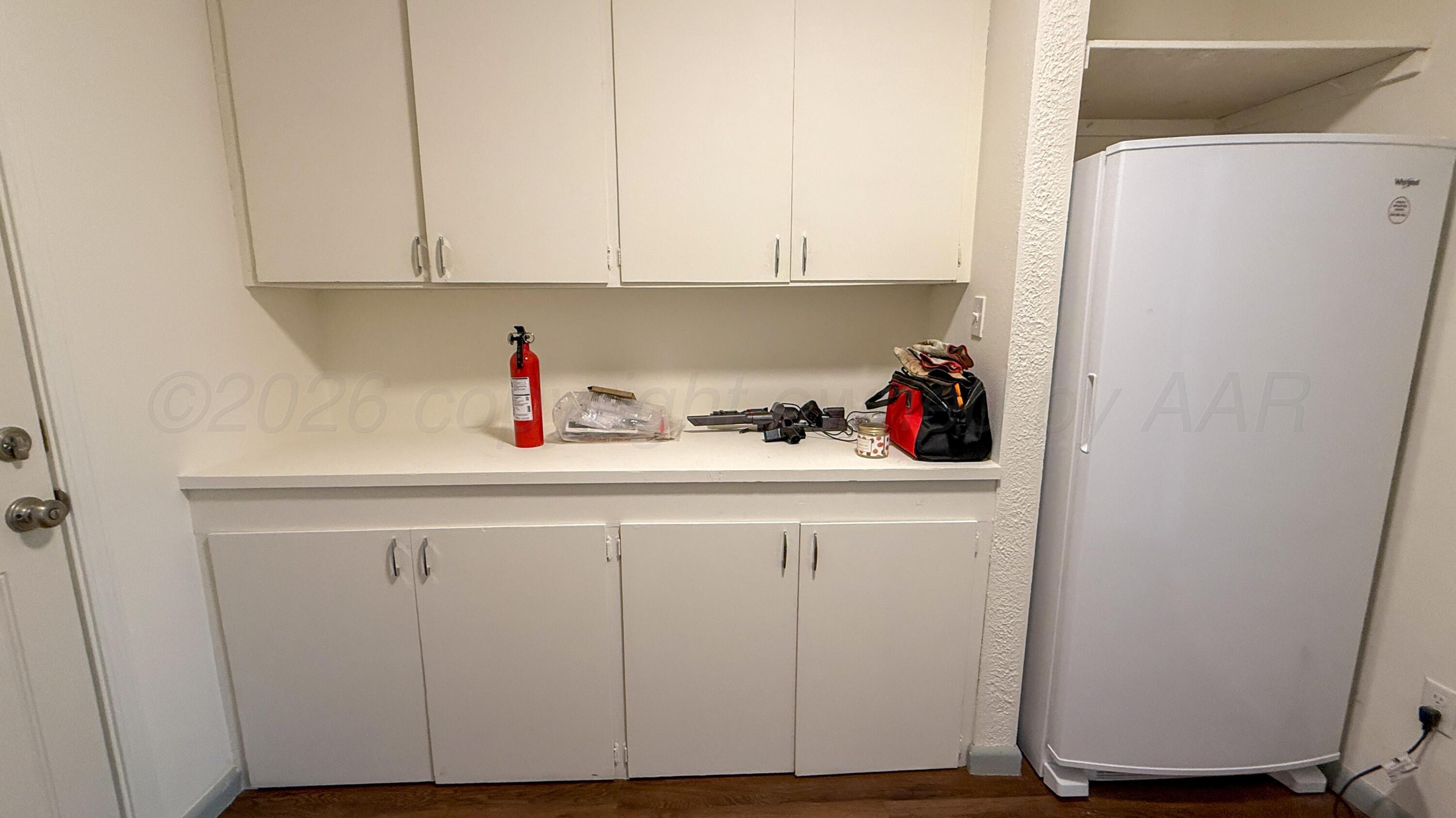 1409 Maple Avenue Panhandle, TX 79068 - Photo 15 of 16 a kitchen with a refrigerator and cabinets