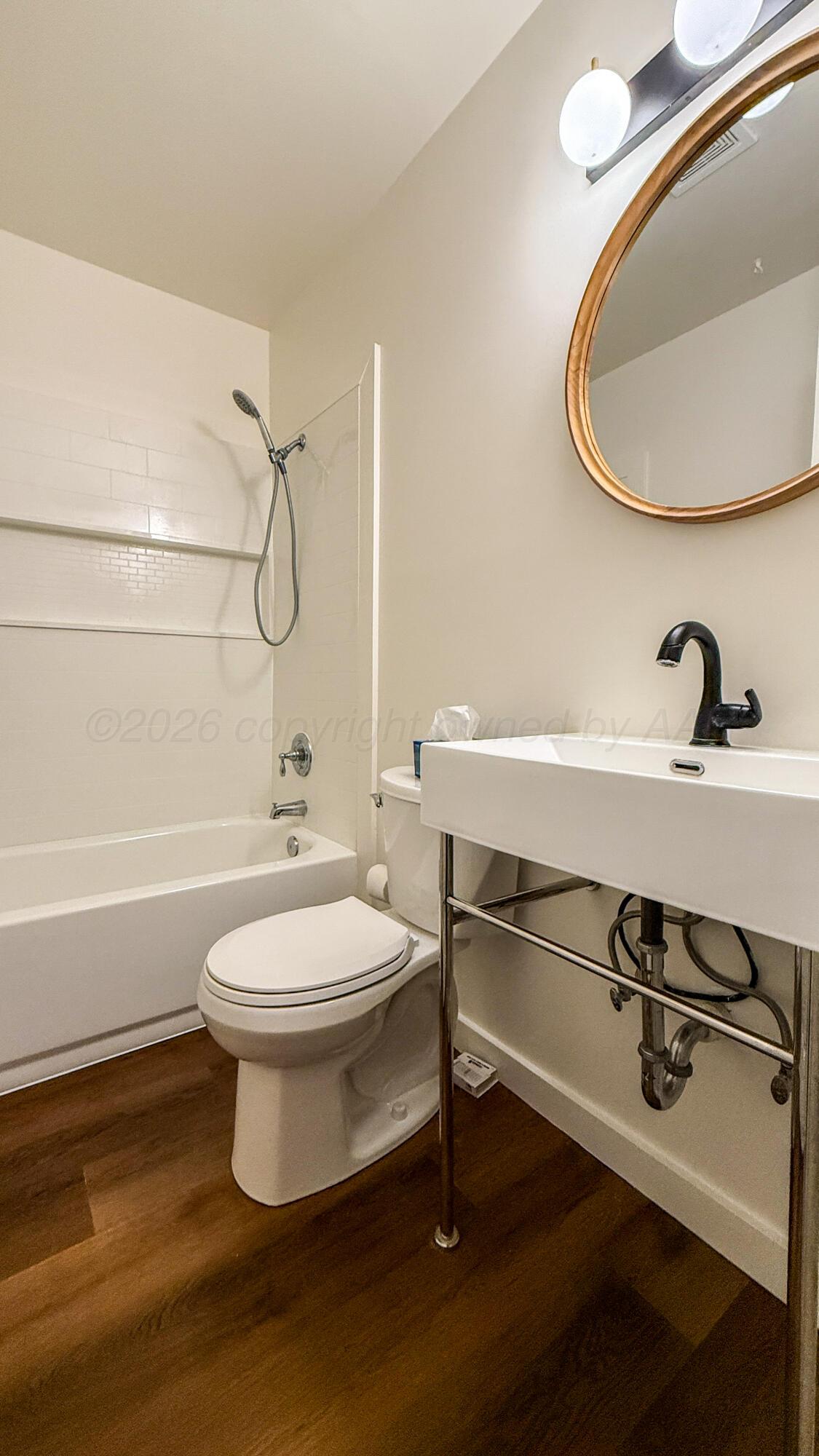 1409 Maple Avenue Panhandle, TX 79068 - Photo 10 of 16 a bathroom with a sink a toilet and a mirror